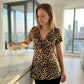 🐆 LIMITED-TIME 50% OFF! ✨ Women’s Leopard Twist-Front Top – V-Neck, Peplum Hem, Bold Print 💃